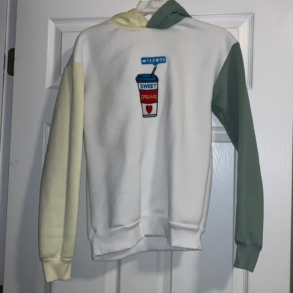 White hoodie with yellow and green sleeves and sweet dreams drinks size medium